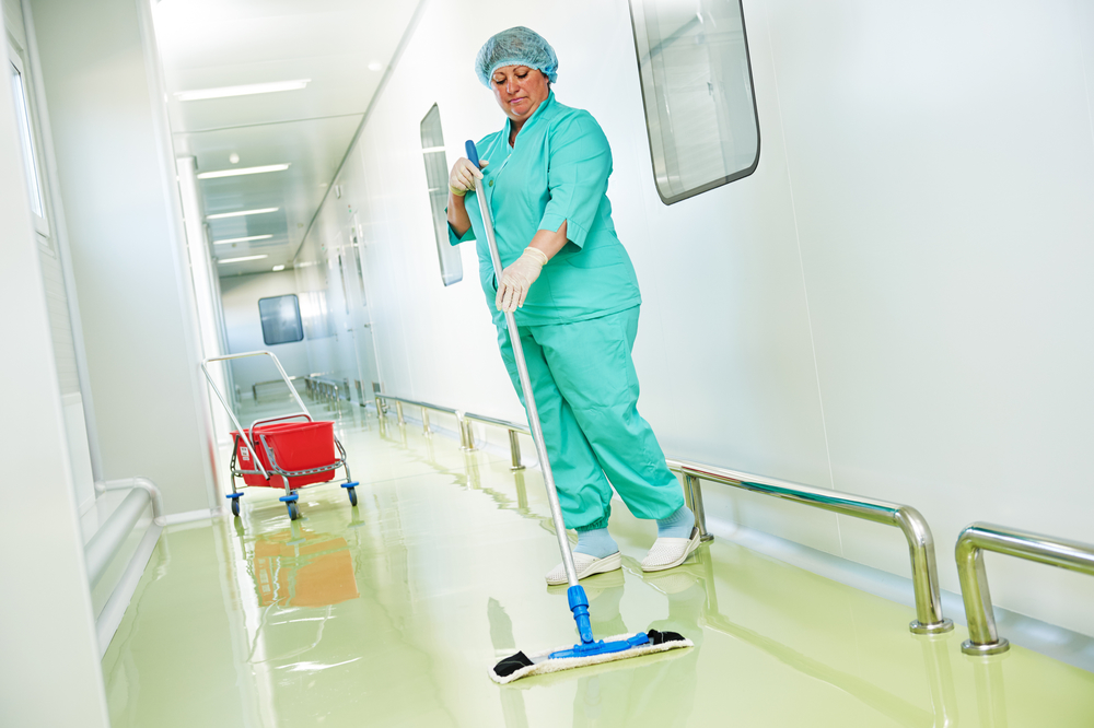 Medical FAcility Cleaning Services worker cleaning floor with machine