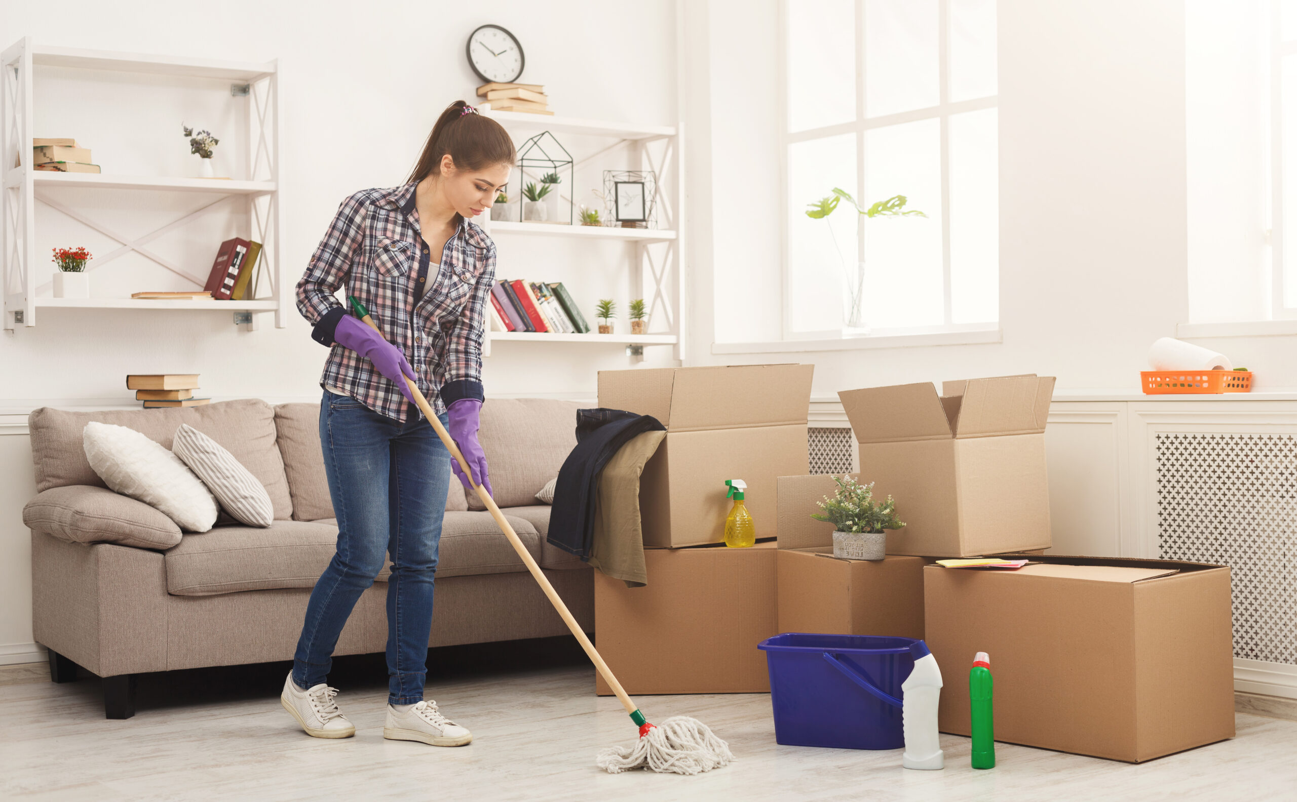 young woman cleaning home with mop scaled